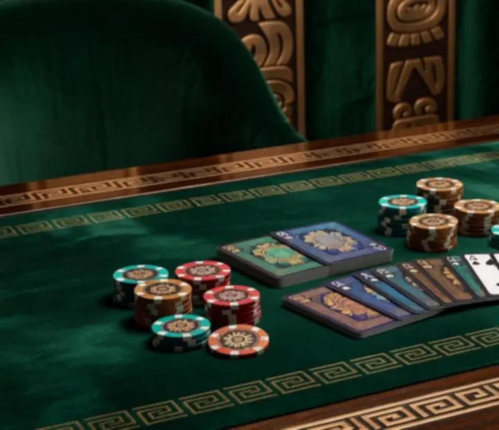 Zbliżenie na żetony, karty i azteckie wzory na stole pokerowym w restauracji Veleoniras